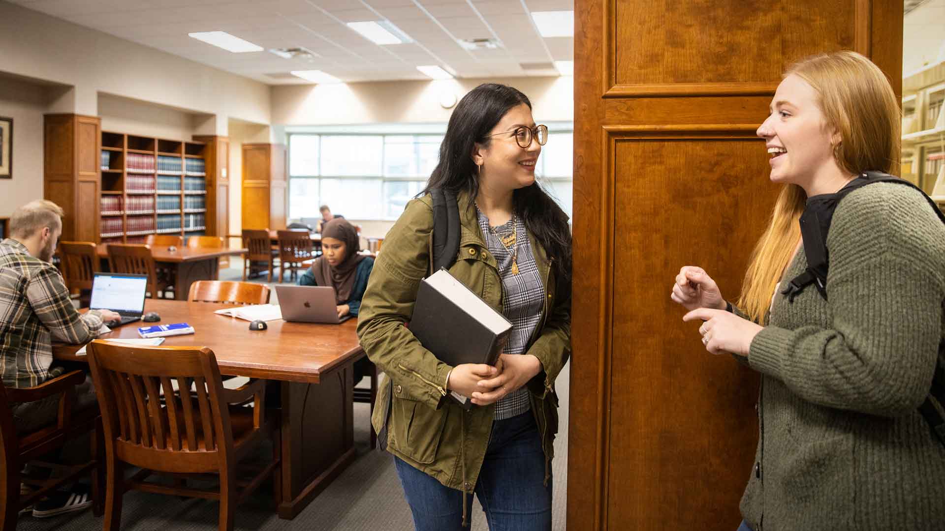 students chat in the library