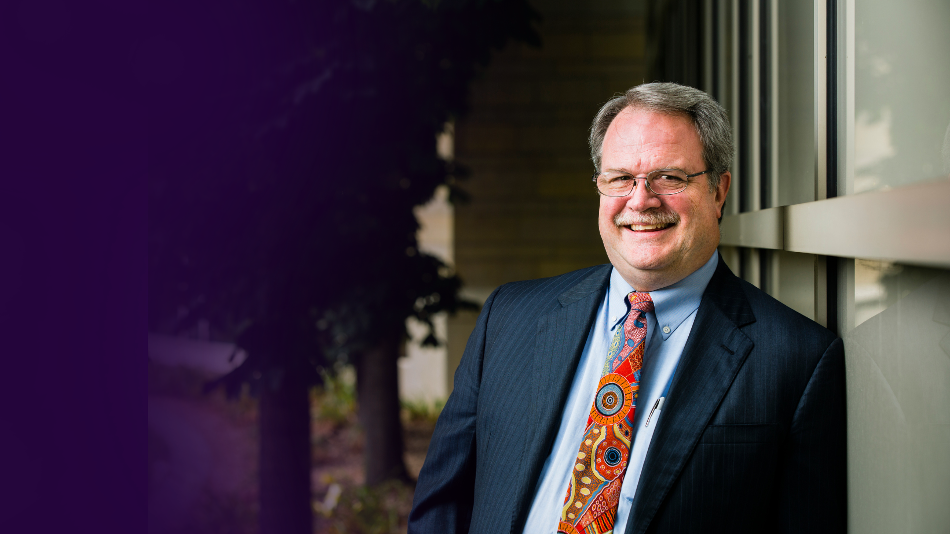 Interim Dean Organ poses in front of the law school building