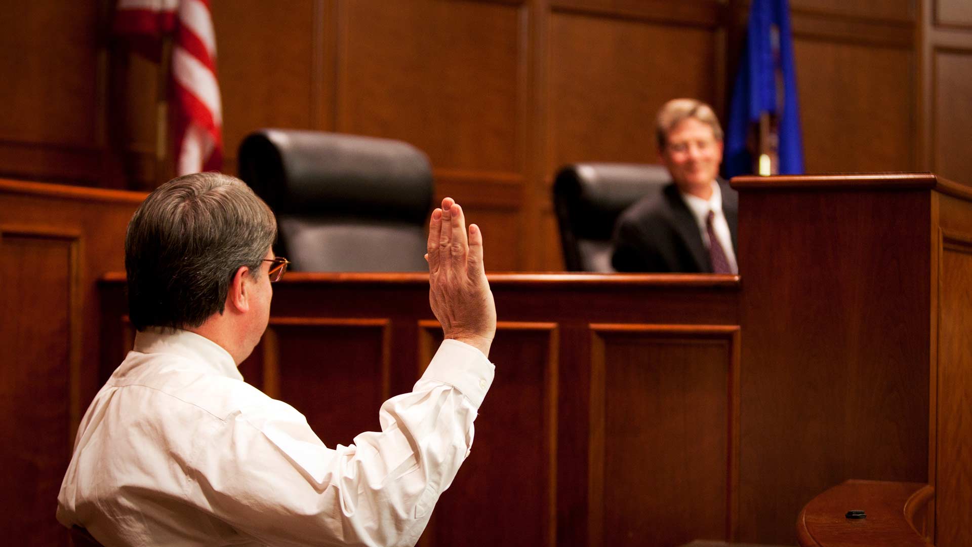 Witness raises their right hand before a judge.