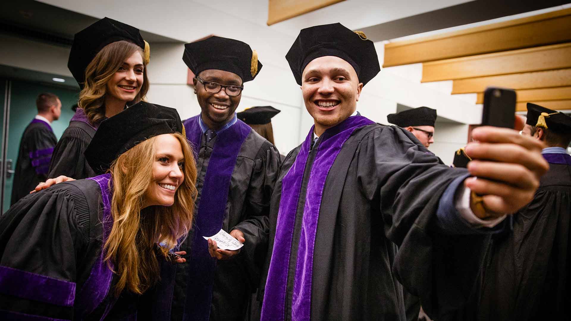 Law students pose for a selfie at graduation.
