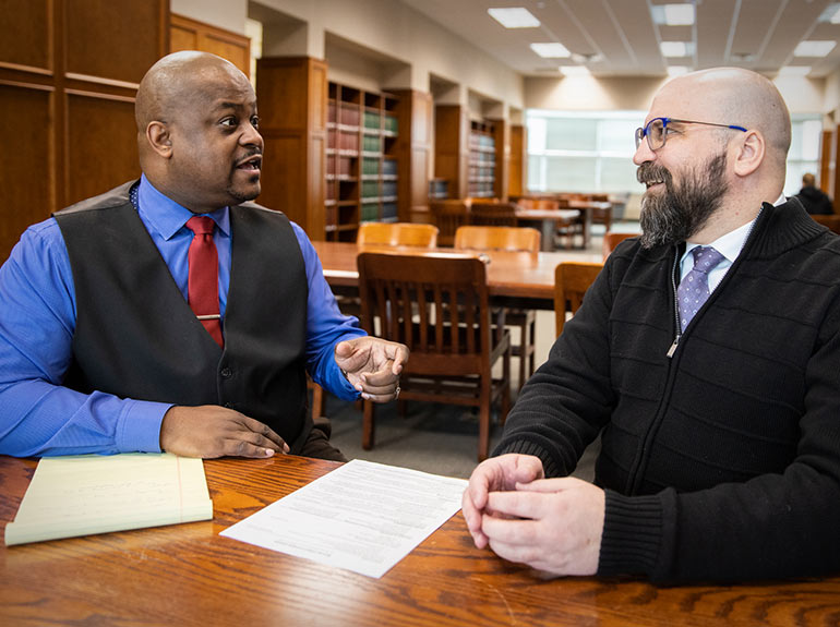 A law school career coordinator speaks with a student.