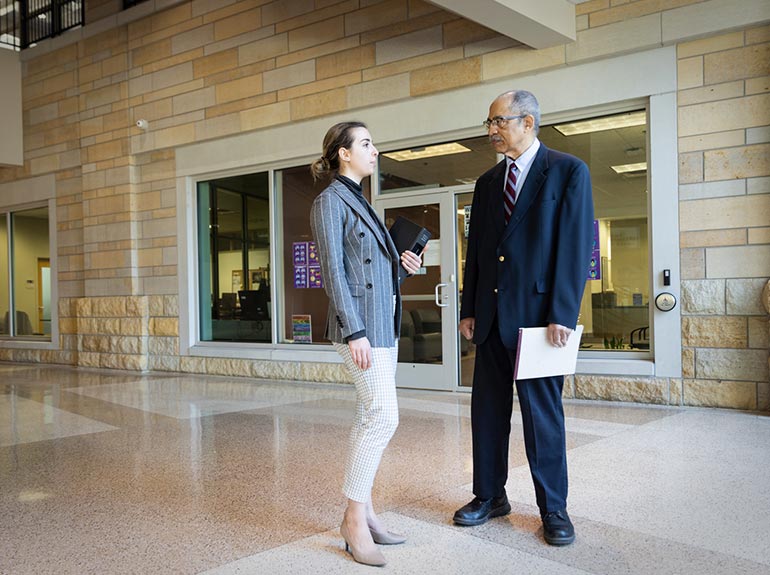 A law school student chats with a professor at the Minneapolis campus.
