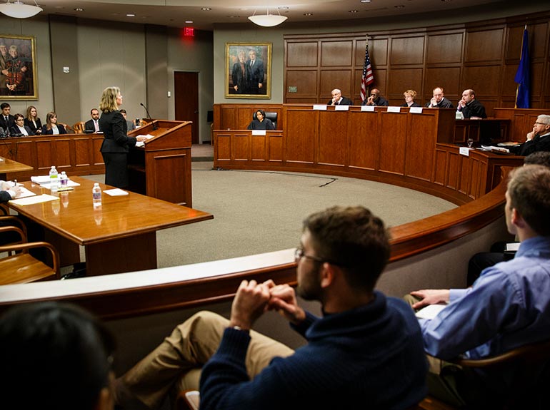 Law students listen to a courtroom presentation.