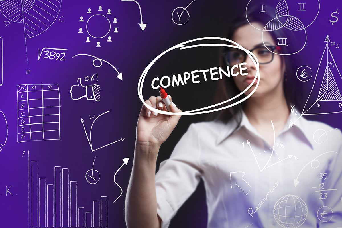 The word "competence" is circled on a board.