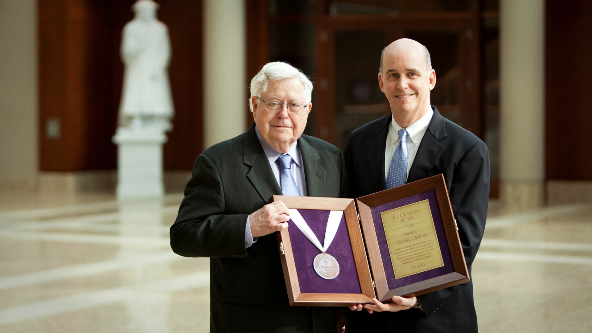 Thomas Holloran holds the Sol Humanae Dignatatus award.