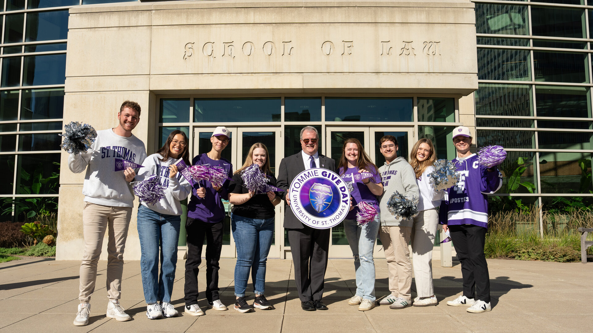 A group of law students and the interim dean in front of the law school building