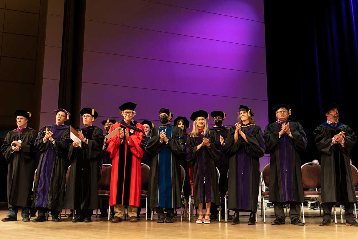 Professors on stage at graduation