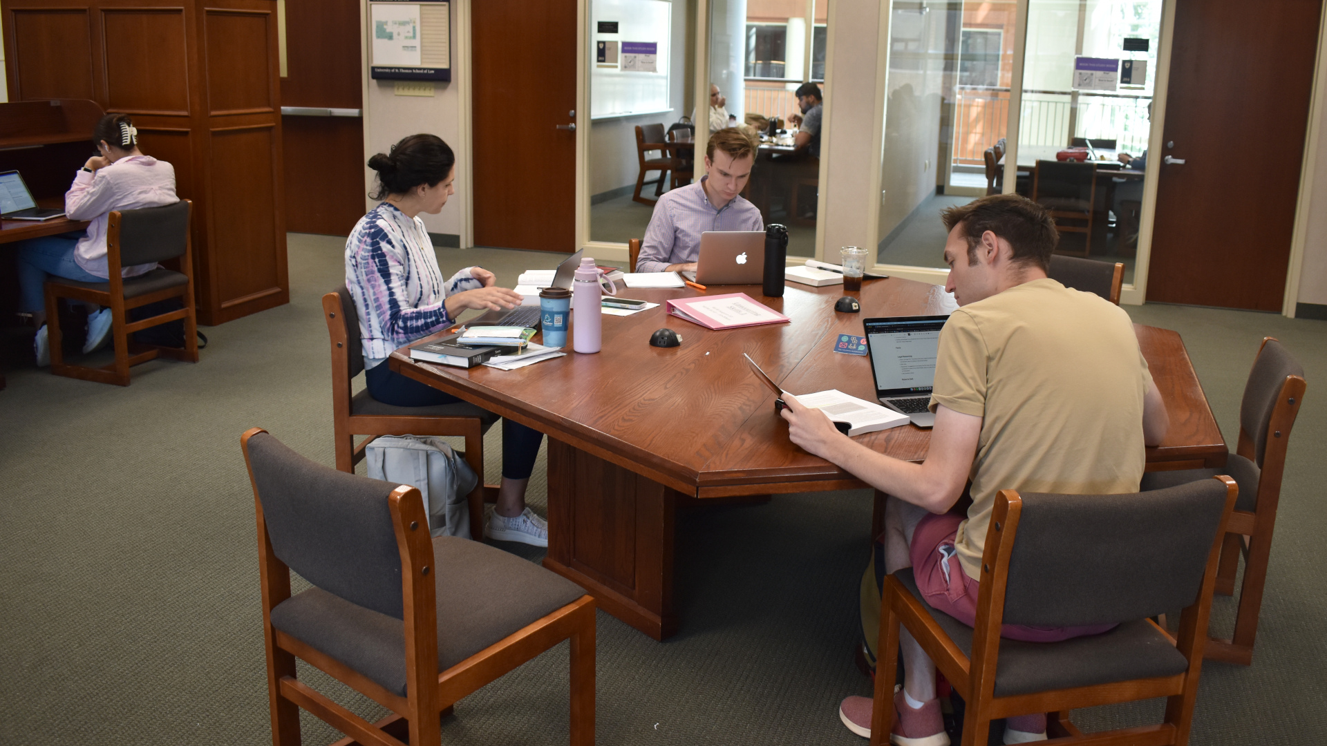 Three law students studying in the library